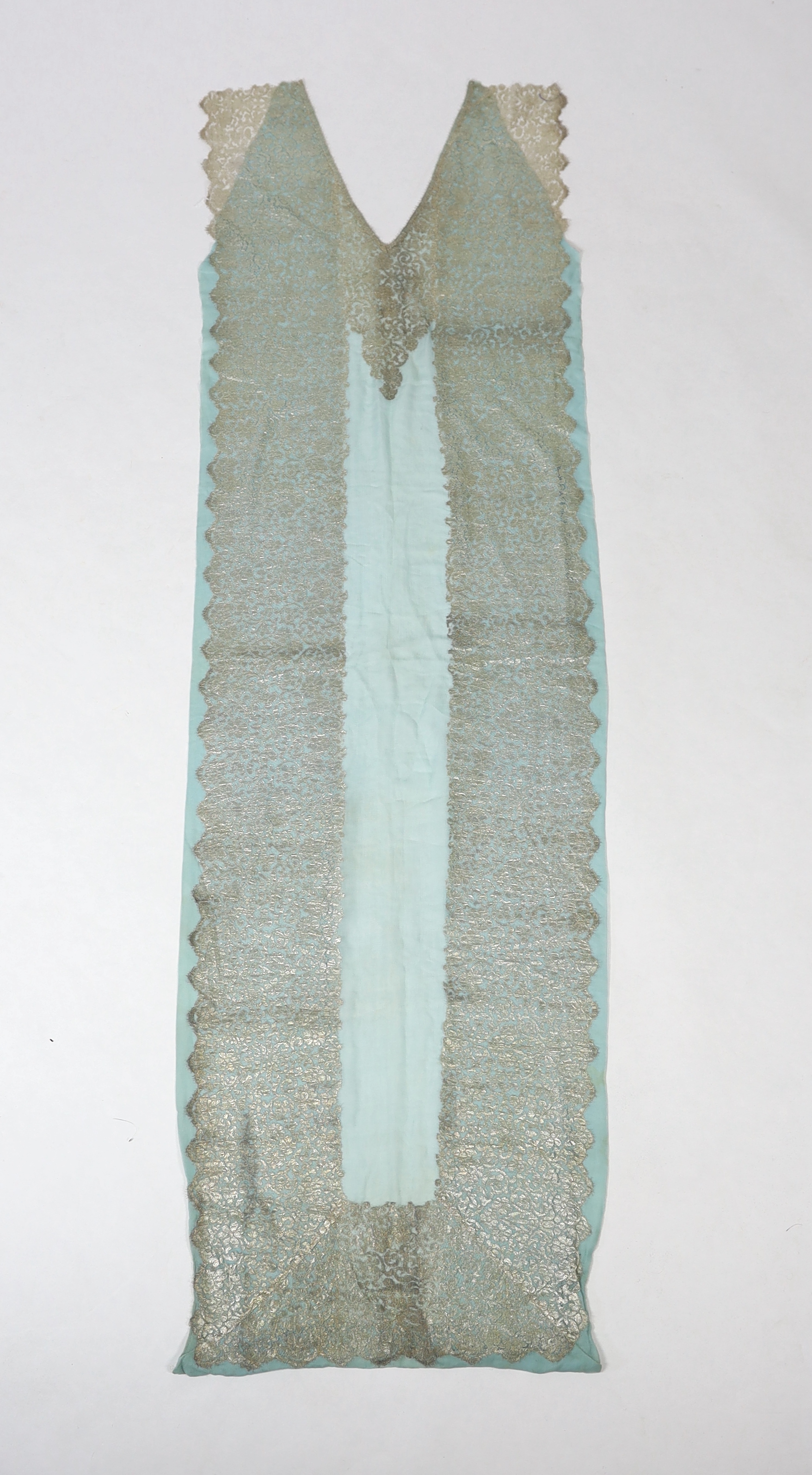 A 1920's silver machine lace and chiffon train, to an evening dress, the silver lace has been cut and appliquéd onto the turquoise chiffon, 209cm long